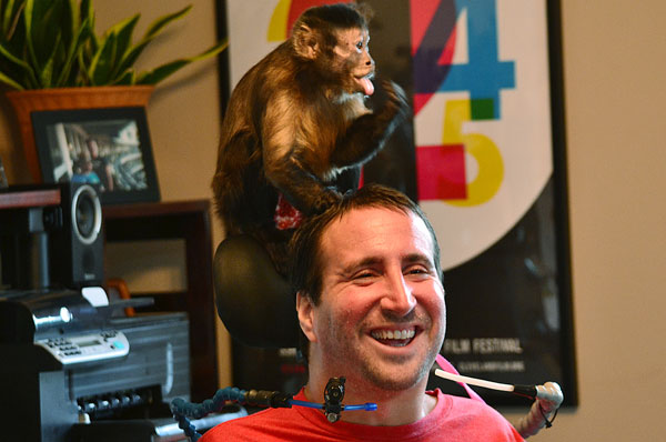 Scott & Melanie - monkey sitting on Scott's wheelchair